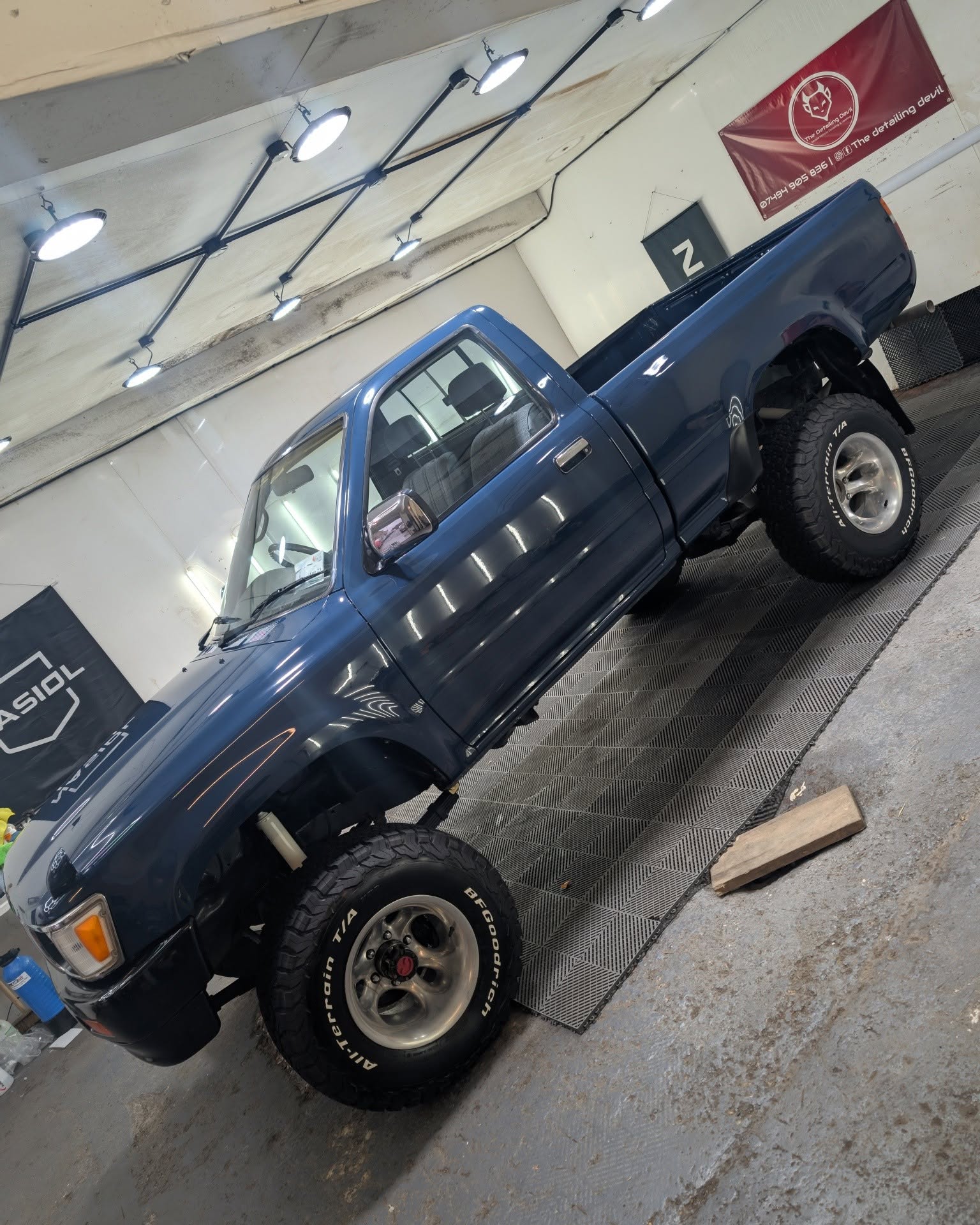 Blue Nissan pickup in the studio