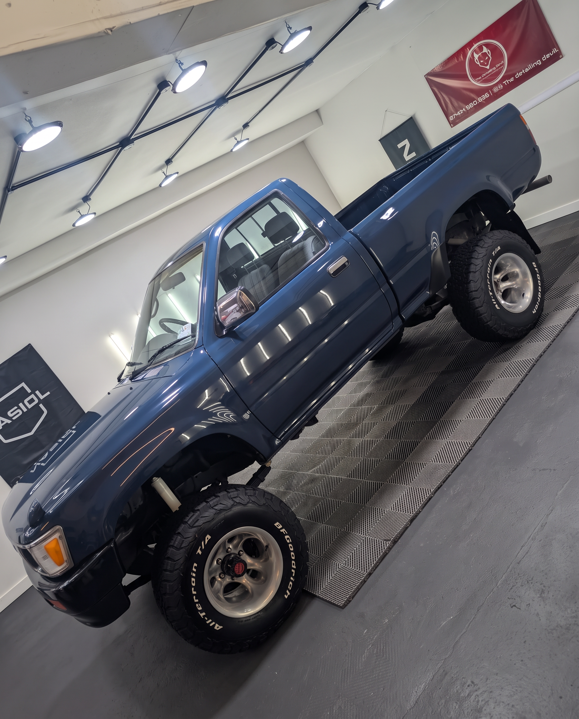 Blue Nissan pickup in the studio